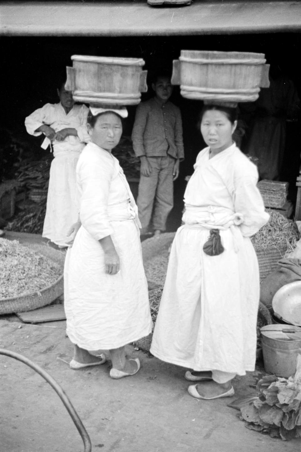 1938 women carrying wood vessels.jpg